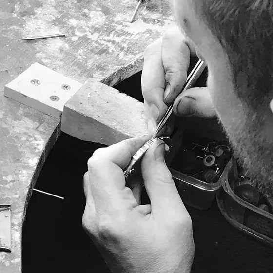 Close-up of a jeweller's hands repairing a piece of jewellery